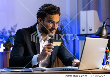 Business man making online purchase payment shopping with credit bank card and laptop at office 134052248