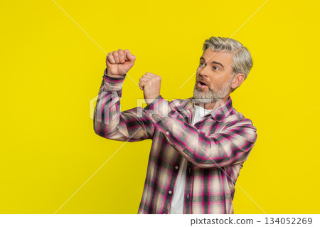 Mature man reaching for invisible target, frantic catch attempt, energetic curiosity air grab Mature man reaching for invisible target, frantic catch attempt, energetic curiosity air grab 134052269