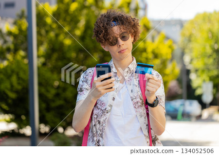 Tourist man using credit bank card smartphone while transferring money, purchases online shopping Tourist man using credit bank card smartphone while transferring money, purchases online shopping 134052506
