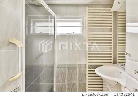 A sleek, modern bathroom featuring a glass shower, a stylish sink, and contemporary design elements, ideal for relaxation and sophistication. A sleek, modern bathroom featuring a glass shower, a stylish sink, and contemporary design elements, ideal for relaxation and sophistication. 134052641
