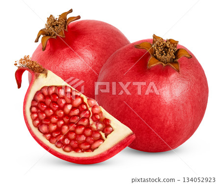 Ripe fresh pomegranate and cut in a slice with seeds isolated. Two red pomegranates and chunk of pomegranate with seeds. Ripe fresh pomegranate and cut in a slice with seeds isolated. Two red pomegranates and chunk of pomegranate with seeds. 134052923