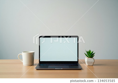 front view of the laptop is on the work table 134053585