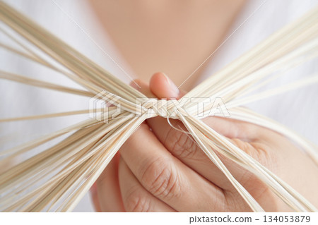 close up of woman making cotton fabric bag 134053879