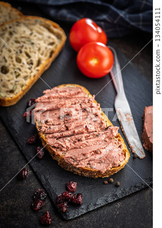 Pate on a slice of bread on black table. 134054111