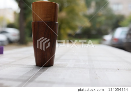 Elegant handmade wood water glass or wooden cup isolated on white background. 134054534