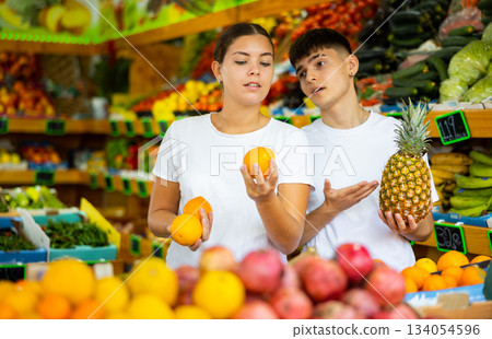 Happy young couple chooses fruits 134054596