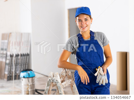 Portrait of a young woman worker in uniform Portrait of a young woman worker in uniform 134054667