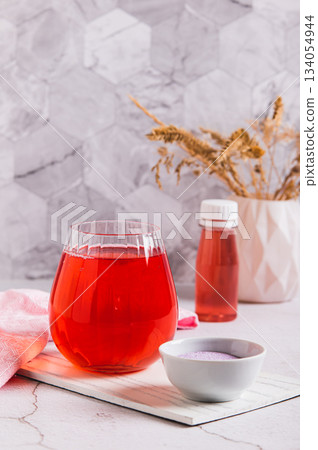 A drink for rapid hydratation and replenishment of fluids and salts in a glass vertical view A drink for rapid hydratation and replenishment of fluids and salts in a glass vertical view 134054944