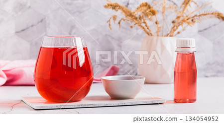 A drink for rapid  hydratation and replenishment of fluids and salts in a glass web banner 134054952