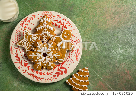 Holiday background. Christmas gingerbread cookies for Santa, festive food, home baking. Flat lay Holiday background. Christmas gingerbread cookies for Santa, festive food, home baking. Flat lay 134055020