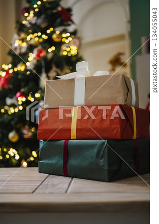 Holiday background, gift boxes next to Christmas tree. Abstract Christmas background, lifestyle. Copy space 134055043