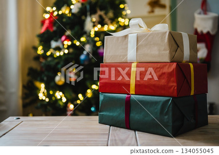 Holiday background, gift boxes next to Christmas tree. Abstract Christmas background, lifestyle. Copy space Holiday background, gift boxes next to Christmas tree. Abstract Christmas background, lifestyle. Copy space 134055045