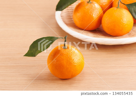Fresh tangerines with leaves Fresh tangerines with leaves 134055435