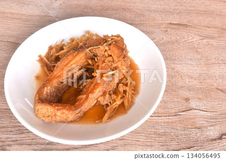 deep fried chop red Tilapia or mango fish slice dressing soy sauce and celery on plate deep fried chop red Tilapia or mango fish slice dressing soy sauce and celery on plate 134056495