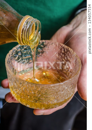 Pouring honey into Bowl During Cooking Prep Pouring honey into Bowl During Cooking Prep 134057554