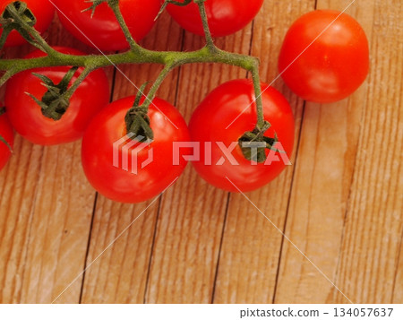 Bunch of red tomatoes are on a wooden table 134057637