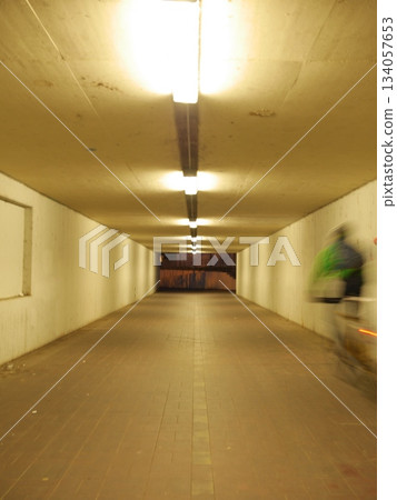 Tunnel with a person riding a bicycle Tunnel with a person riding a bicycle 134057653
