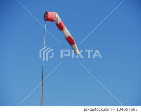 Red and white kite is flying in the sky Red and white kite is flying in the sky 134057663