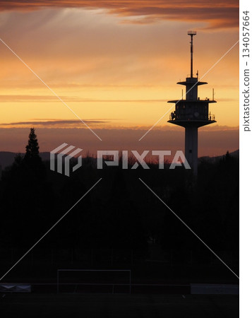 Tall tower is silhouetted against a beautiful sunset Tall tower is silhouetted against a beautiful sunset 134057664