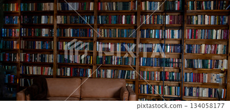 Book background. Bookshelves in the library. Book background. Large bookcase with lots of books. Library or shop with bookcases. 134058177