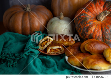 Pumpkin patties. Autumn food. You are on the table. A treat for Halloween. Still life. Sweet pastries with filling. Pie. Pumpkin patties. Autumn food. You are on the table. A treat for Halloween. Still life. Sweet pastries with filling. Pie. 134058208