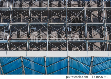 Scaffolding construction at a demolition site: Morning glory and soundproofing panels Scaffolding construction at a demolition site: Morning glory and soundproofing panels 134058969