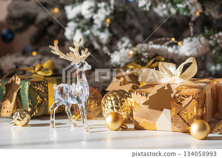 Crystal Reindeer with Gold Antlers and Christmas Gifts in Festive Interior 134058993