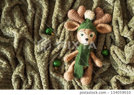 Crocheted Reindeer with Christmas Ornaments on Cozy Holiday Blanket 134059010