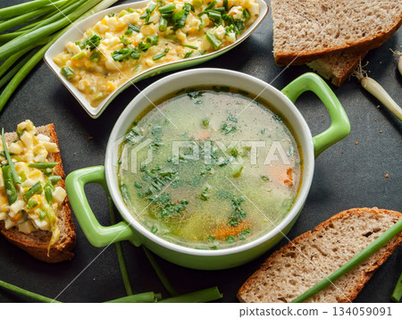 Homemade lunch healthy chicken broth with veggies and egg sandwiches for cold season. Homemade lunch healthy chicken broth with veggies and egg sandwiches for cold season. 134059091