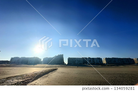 A Breathtaking Coastal Sunset Over Urban Residences Illuminated by the Evening Light 134059281