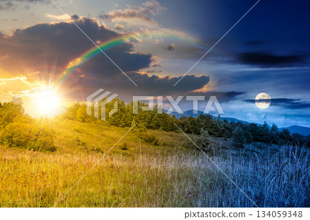mountain landscape with foliage forest on autumn equinox. day and night time change concept. beautiful beech woodland on rolling hills in highland with sun and moon. duality and transition template 134059348