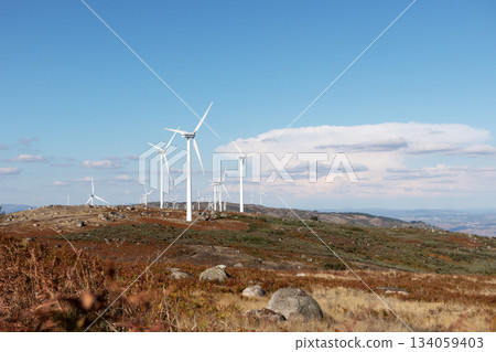Wind turbines on mountain landscape generating renewable energy. Eco-friendly wind farm 134059403