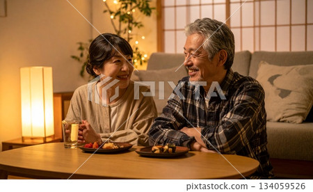 A peaceful evening: A couple enjoying a quiet drink at home 134059526