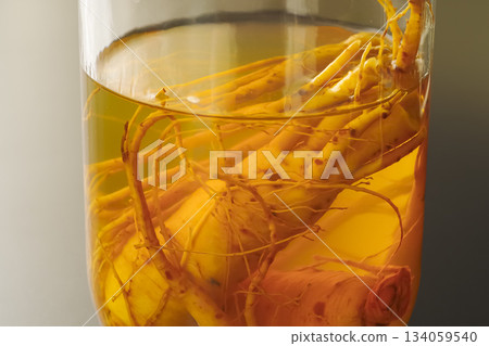 A bottle of medicinal liquor steeped in ginseng A bottle of medicinal liquor steeped in ginseng 134059540