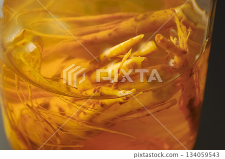 A bottle of medicinal liquor steeped in ginseng A bottle of medicinal liquor steeped in ginseng 134059543