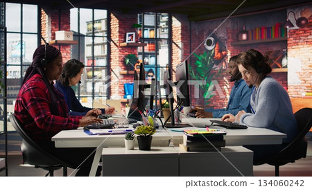 Worker providing live chat support, typing on keyboard, handling clients complaints. Call center agent dealing with unsatisfied customers, providing helpful solutions to their concerns, camera B Worker providing live chat support, typing on keyboard, handling clients complaints. Call center agent dealing with unsatisfied customers, providing helpful solutions to their concerns, camera B 134060242