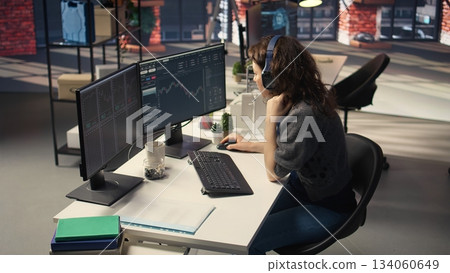 Financial investor works on PC analyzing stock market trends. The digital interface displays price fluctuations, candlestick charts. Liquidity statistics helps strategize future trading decisions Financial investor works on PC analyzing stock market trends. The digital interface displays price fluctuations, candlestick charts. Liquidity statistics helps strategize future trading decisions 134060649