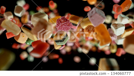 Colorful candies flying in mid-air against a black background. Dynamic macro shot with vibrant colors, shallow depth of field, and motion freeze. Perfect for food, advertising, and creative design. Colorful candies flying in mid-air against a black background. Dynamic macro shot with vibrant colors, shallow depth of field, and motion freeze. Perfect for food, advertising, and creative design. 134060777