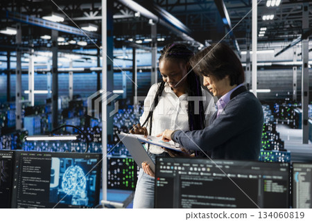 Team leader in data center teaching intern to optimize hardware for AI tasks. Server hub IT manager guiding trainee learning to automate systems using deep learning during internship Team leader in data center teaching intern to optimize hardware for AI tasks. Server hub IT manager guiding trainee learning to automate systems using deep learning during internship 134060819
