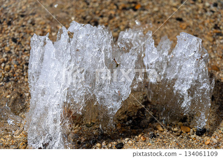 Ice formation on sandy beach creating unique natural sculpture Ice formation on sandy beach creating unique natural sculpture 134061109