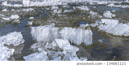 Ice blocks floating on water surface in a natural winter landscape 134061121