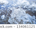 Close-up of shimmering ice crystals reflecting sunlight on water surface 134061125