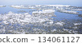 Ice fragments floating on calm water surface in serene natural environment Spring banner 134061127