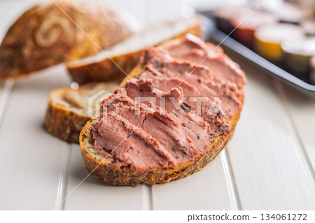 Pate on a slice of bread on white table. Pate on a slice of bread on white table. 134061272