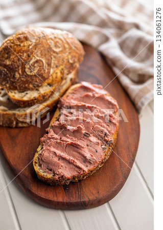 Pate on a slice of bread on white table. Pate on a slice of bread on white table. 134061276