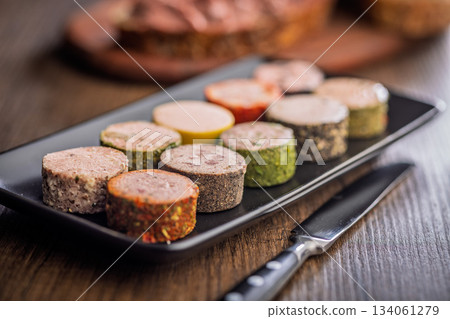 Liver pate with cranberries on plate on wooden table. 134061279