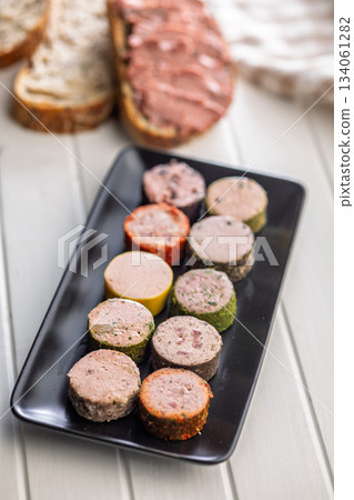 Liver pate with cranberries on plate on white table. Liver pate with cranberries on plate on white table. 134061282