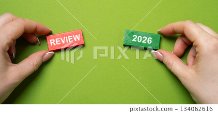 Audit of business and enterprises, government agencies and services. Annual report and financial performance indicators. Business and finance concept. Blocks with the words Review 2026 in hand. Audit of business and enterprises, government agencies and services. Annual report and financial performance indicators. Business and finance concept. Blocks with the words Review 2026 in hand. 134062616