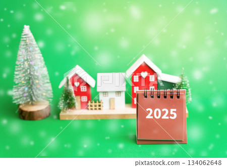 calendar 2025 with houses and Christmas tree. Summing up the year. Happy New Year or Xmas winter holiday. Decoration, celebration. Snow, snowfall 134062648