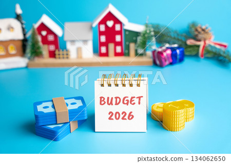 A notebook with the words Budget 2026 and money against a New Year city backdrop. Financial planning for the New Year. Money management and economics concepts. A notebook with the words Budget 2026 and money against a New Year city backdrop. Financial planning for the New Year. Money management and economics concepts. 134062650